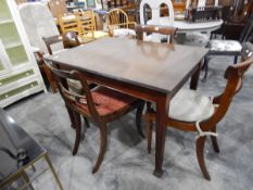 A rectangular mahogany dining table on tapering fluted supports,