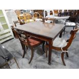 A rectangular mahogany dining table on tapering fluted supports,