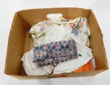 A Liberty silk jewellery roll, embroidered mats, floral apron, etc.