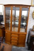 A modern display cabinet with drawers and cupboards to base,