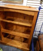 A pine open bookshelf with three shelves, shaped block feet,