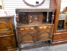 A 1930's oak court cupboard,