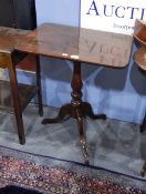 A mahogany pedestal table on turned column and shaped tripod supports