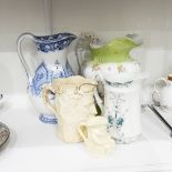 A Victorian toilet jug decorated in blue and white with flowers and four other jugs (5)