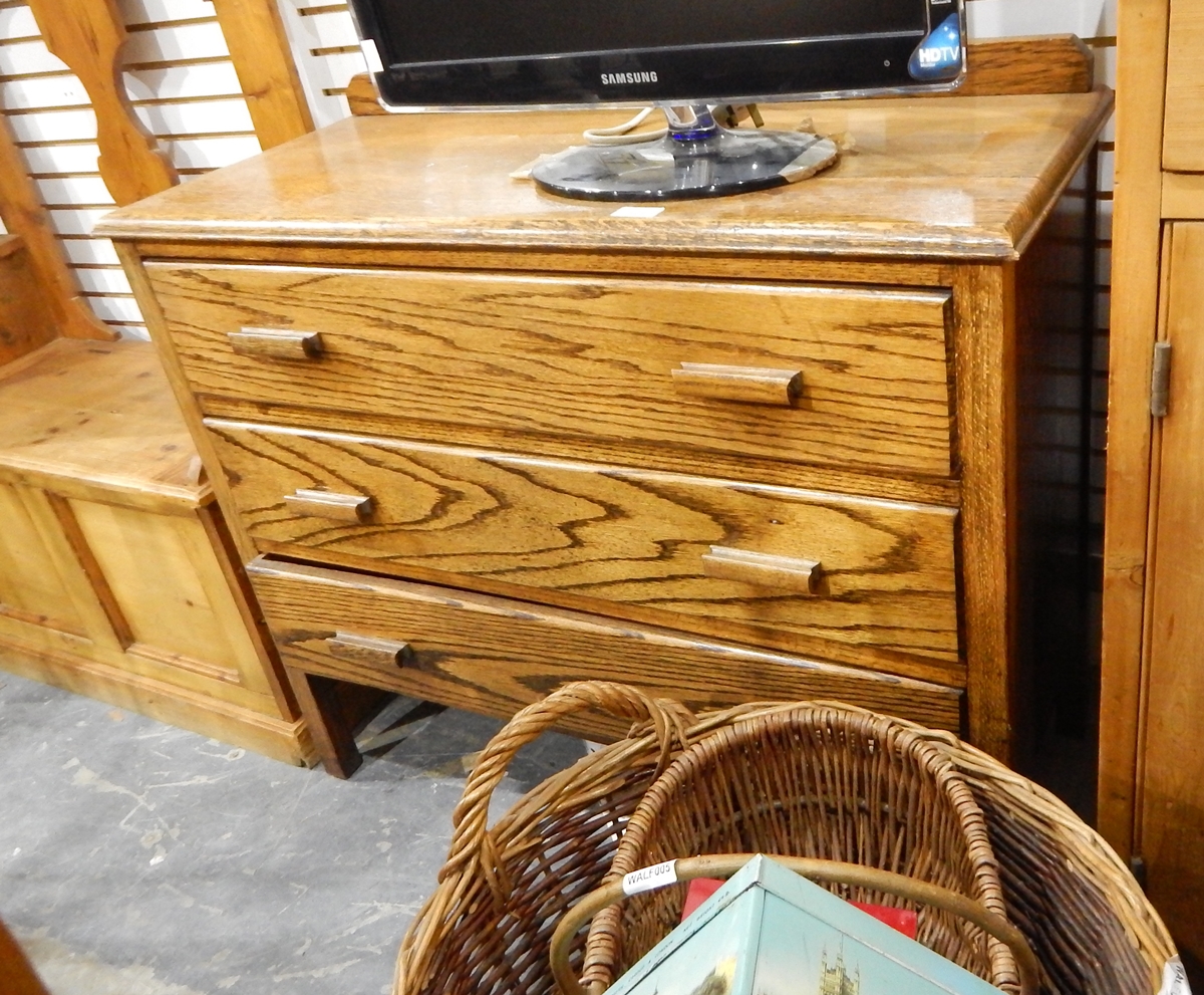 An oak dressing chest of three long drawers on square tapering legs,