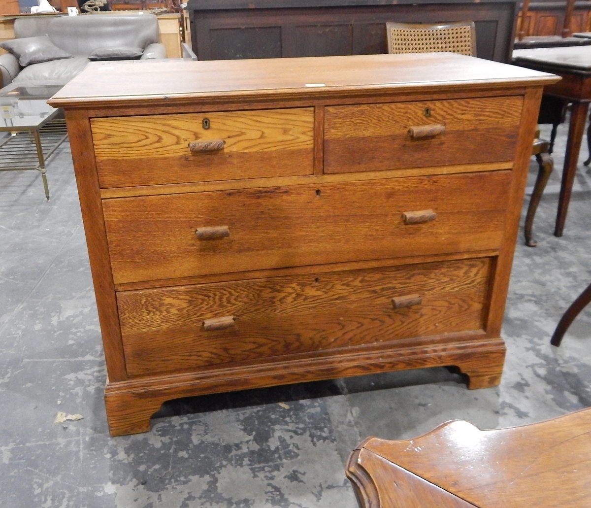 A 20th century oak chest of two short and two long drawers, on bracket feet,