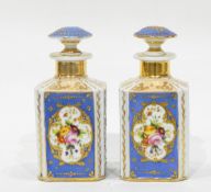 A pair of continental porcelain scent flasks and stoppers of square form,