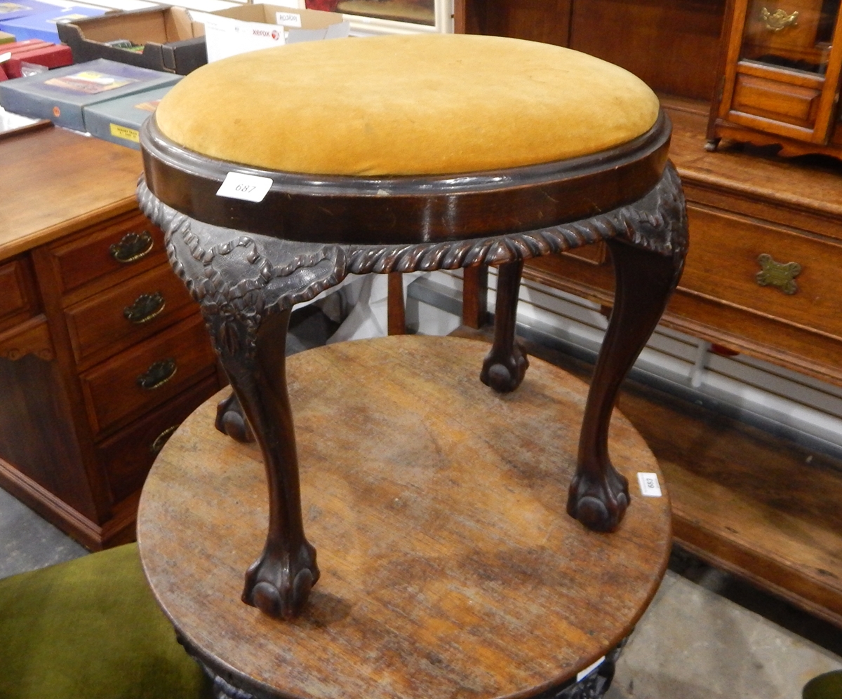 An early 20th century oval mahogany pad seat dressing stool with gadrooned carved apron,