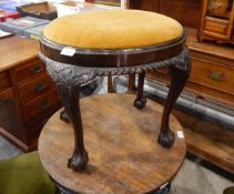 An early 20th century oval mahogany pad seat dressing stool with gadrooned carved apron,