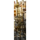 A brass fire companion with two candle holders, the fire irons hanging from a frame,