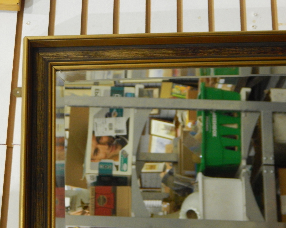 A 20th century gilt painted framed mirror with bevelled edge,