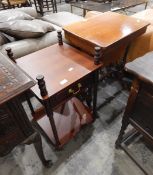 An oak sewing table with concealed under cupboard,