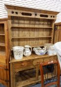 A 20th century pine Welsh dresser with three short drawers, cupboard to base, serpentine skirt,