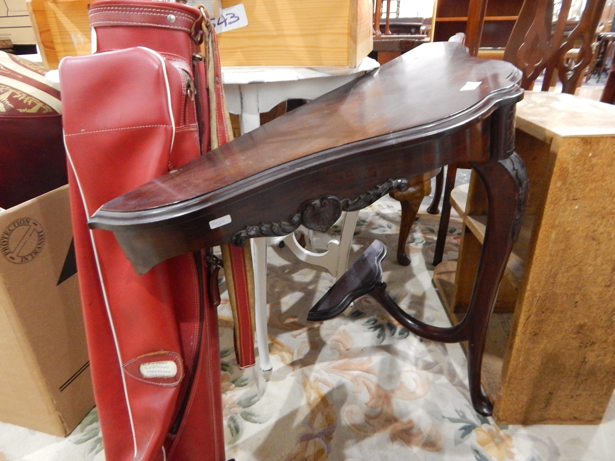 A shaped mahogany hall table having a single carved and cabriole shaped support with small