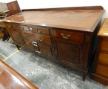 An oak sideboard with four short and one long drawer, three cupboards,