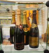 A bottle of Veuve Clicquot Ponsardin champagne (boxed), another (unboxed),