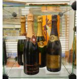 A bottle of Veuve Clicquot Ponsardin champagne (boxed), another (unboxed),