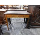 An Edwardian writing table with inset leatherette to frieze,