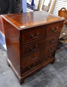 A 20th century mahogany walnut veneered chest of two short and three long drawers,