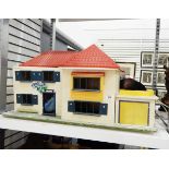 A 20th century doll's house with red roof and garage,