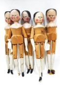 Five 19th century pine dolls, each with articulated joints and naively painted heads, arms and legs,