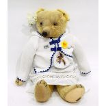 A Merrythought plush bear with glass eyes and button to ear,