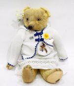 A Merrythought plush bear with glass eyes and button to ear,