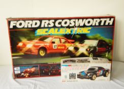 The Scalextric's Ford RS Cosworth set to include cars and track, boxed,