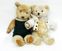 A plush teddy bear with plastic eyes and another dressed in a knitted green romper suit (2)