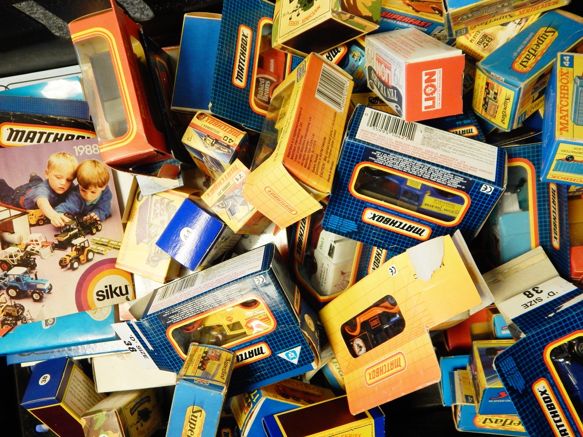 A collection of Matchbox diecast model cars in original boxes and accompanying Matchbox reference