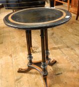 Ebonised circular occasional table with strung burr walnut border, on fluted columns,