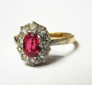Pink stone and diamond cluster ring set oval facet-cut pink stone,