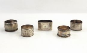 Five assorted silver napkin rings, one with engine-turned decoration and engraved 'Pam',
