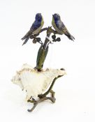 19th century painted led model of two blue birds on branch with shell scroll base,