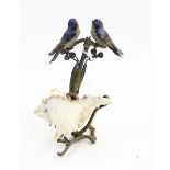 19th century painted led model of two blue birds on branch with shell scroll base,