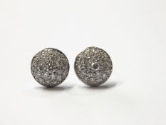 Pair white gold and diamond earrings, each circular and slightly domed,