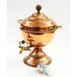Copper hot water urn with brass handle and tap, on flared circular base,