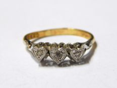 Three stone diamond ring, the three graduated eight cut diamonds in heart-shaped settings,