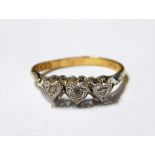 Three stone diamond ring, the three graduated eight cut diamonds in heart-shaped settings,