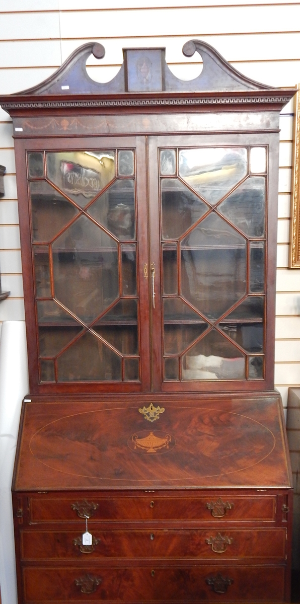 Georgian flame mahogany bureau bookcase, the top with swan neck pediment, urn and swag inlay,