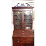 Georgian flame mahogany bureau bookcase, the top with swan neck pediment, urn and swag inlay,