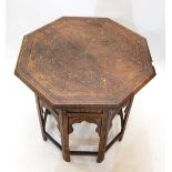 Octagonal Eastern folding occasional table with brass scroll and floral inlay,