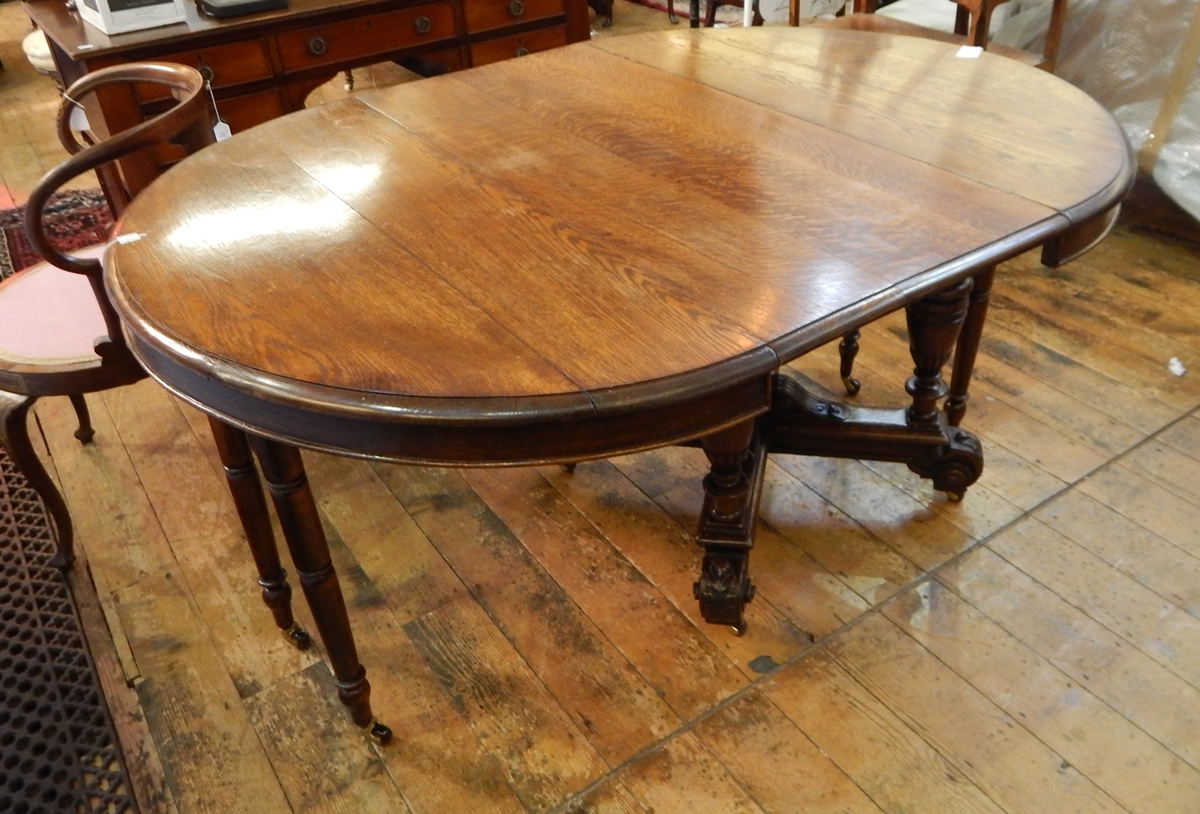 Early 20th century oval extending dining table with three extra leaves,