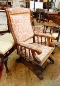 Victorian rocking chair with red and cream floral upholstery,