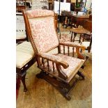 Victorian rocking chair with red and cream floral upholstery,