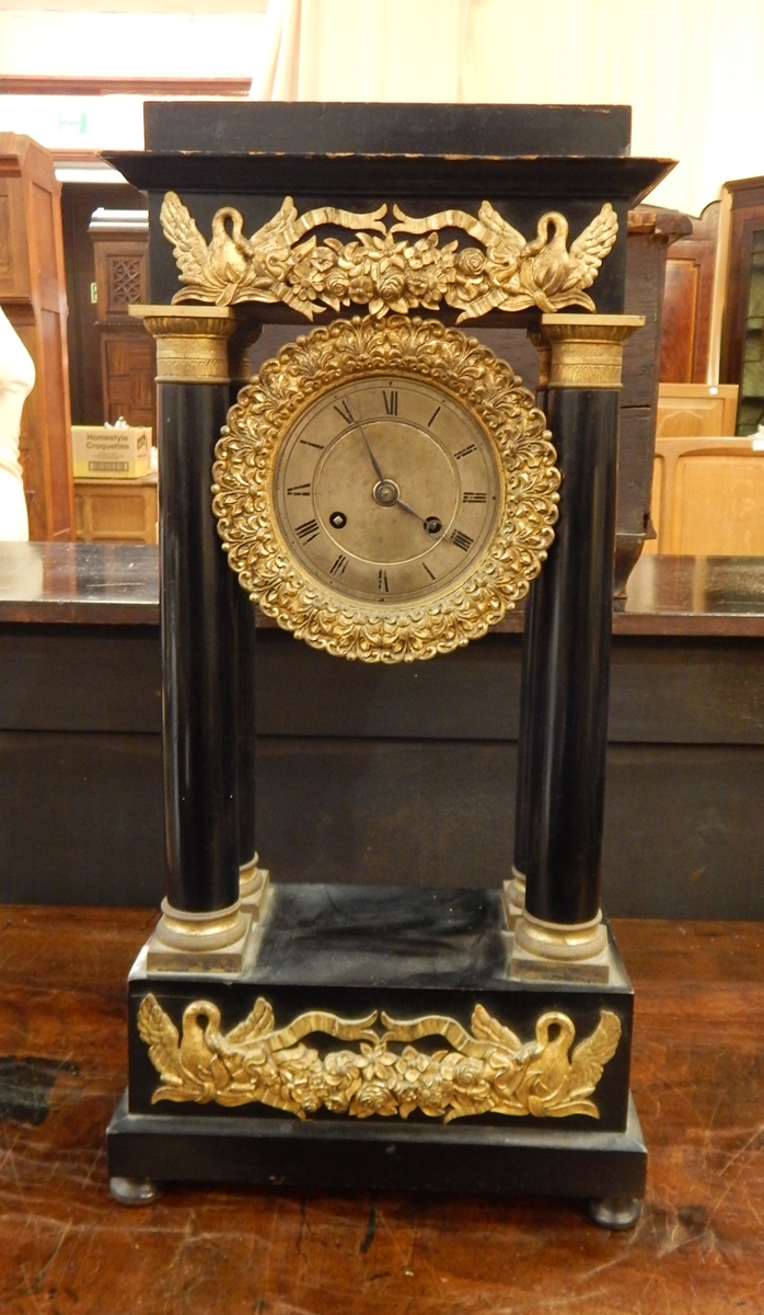 Continental four-pillar ormolu mounted and ebonised mantel clock with foliate and swan