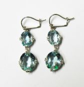 Pair of aquamarine drop earrings, each set with two graduated oval mixed cut aquamarine,