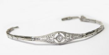 White gold and diamond bracelet set with a central brilliant cut diamond within a pierced surround