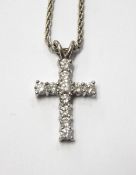 18ct white gold and diamond cross pendant, the brilliant cut stones all claw set, approx.