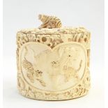 Japanese carved ivory tusk box, oval and lidded having elephants and tigers in two reserves,